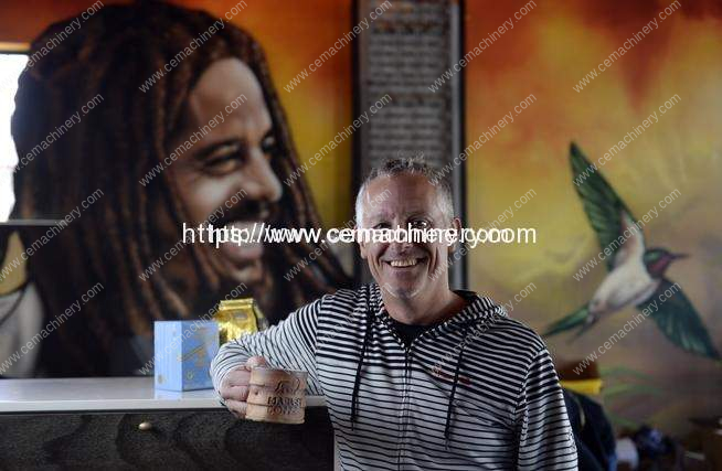 Brent Toevs CEO of Marley Coffee at his Denver office with several Marley Coffee product